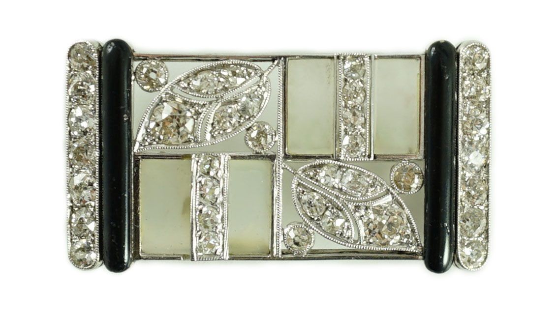 A 1930's/1940's Austro-Hungarian white gold, millegrain set diamond, frosted glass and black enamel rectangular brooch